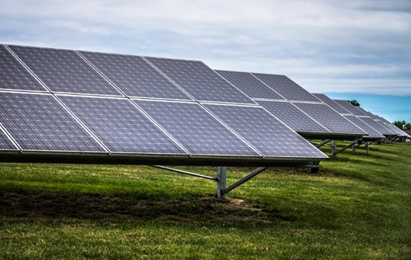 paineis-solares-em-um-campo-gramado-contra-um-ceu-nublado (1)-min 1-min